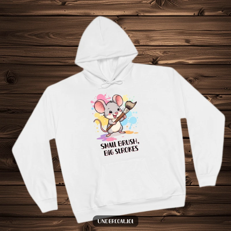 Funny mouse art hoodie, a tiny mouse artist creating a colorful paint splatter with a large brush, warm and fun.