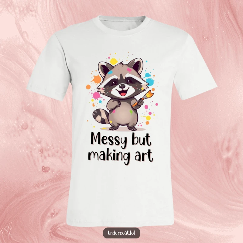Funny raccoon t-shirt featuring a joyful raccoon splattering vibrant paint with a brush, perfect for creative expression.